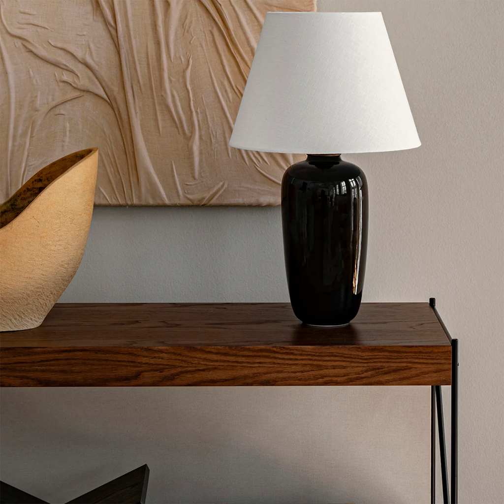 Torso Table Lamp styled on side table in modern living room with neutral tones