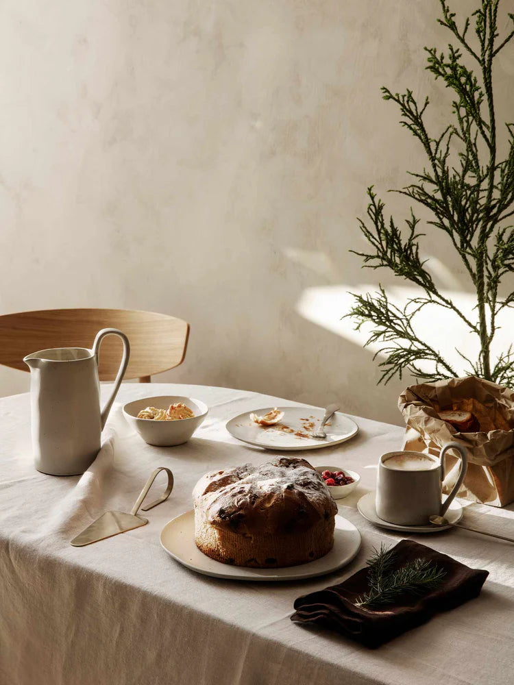 Flow Plate Off-White Speckle set styled on dining table — minimal Scandinavian tableware.