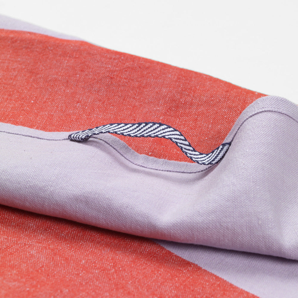 Close up image of Ferm Living Hale Tea Towel in Red / Lilac showing fabric detail and hanging hook.