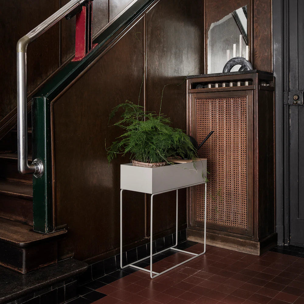 Ferm Living Plant Box in Light Grey styled in a vintage hallway with dark wood paneling, tiled floor, and greenery for a refined modern contrast.