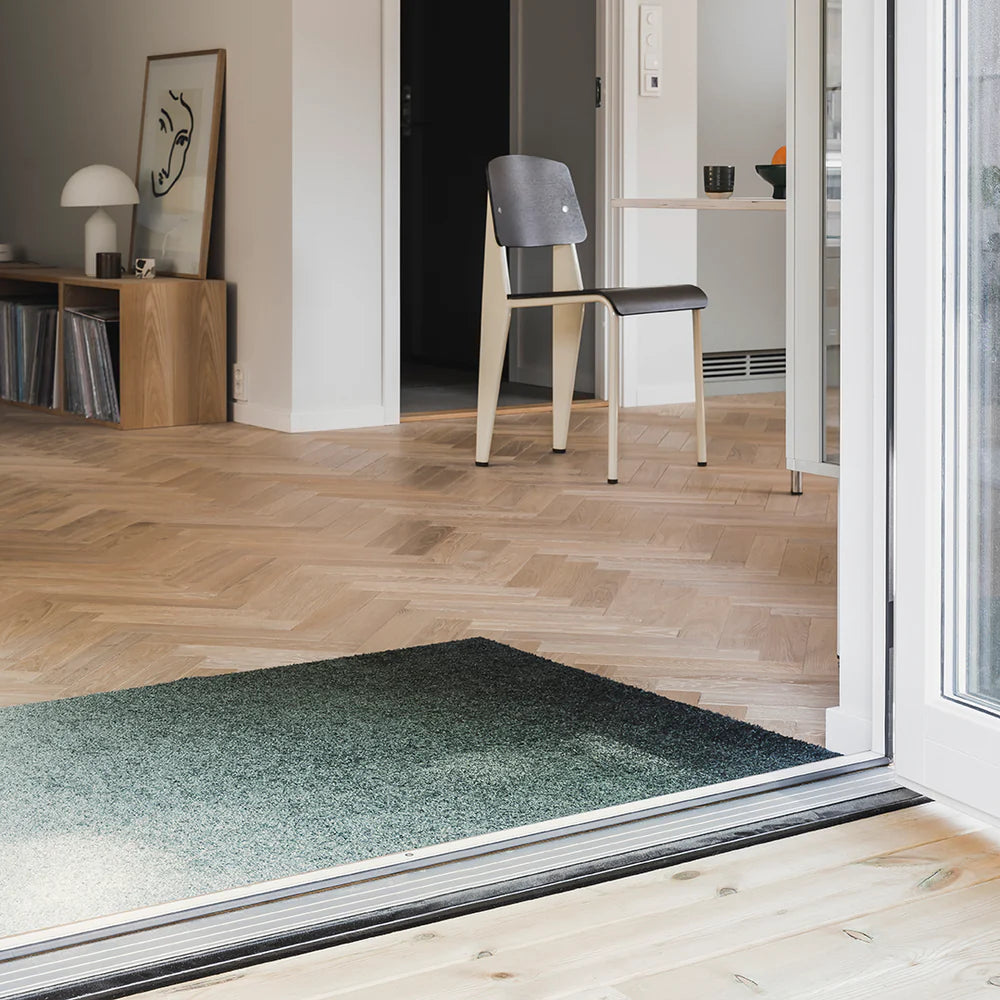 Dis Ocean ombré doormat, styled with light wood parquet floors and soft neutrals for a calm entryway