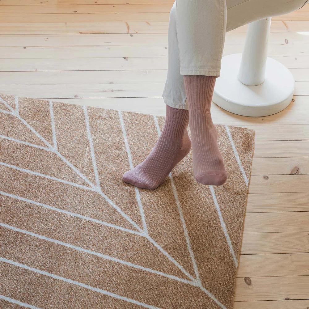 Heymat Eine doormat color Dawn, slip-resistant and machine-washable. Shown in a minimalist Scandinavian interior with light wood accents.