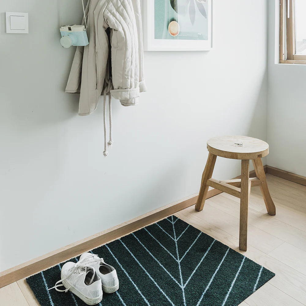 Eine Noon light geometric doormat, styled in bright Scandinavian entryway with pale wood and minimalist decor.
