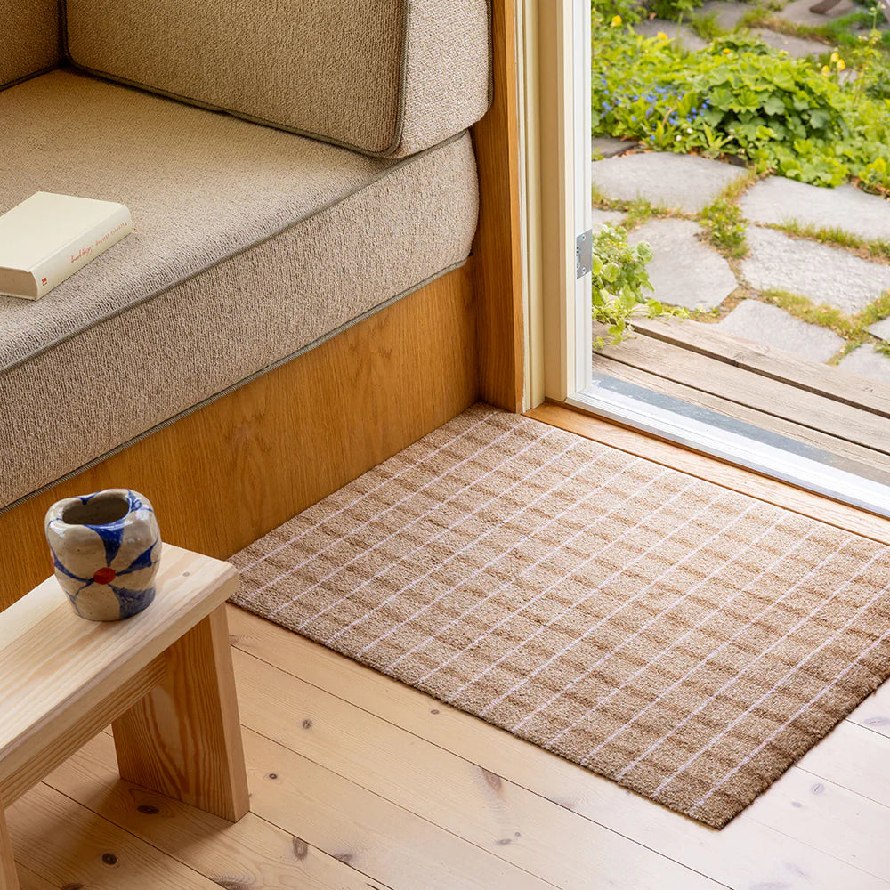 Heymat Grid Chocolate Strawberry doormat with square grid design, styled in minimalist entryway with neutral décor.