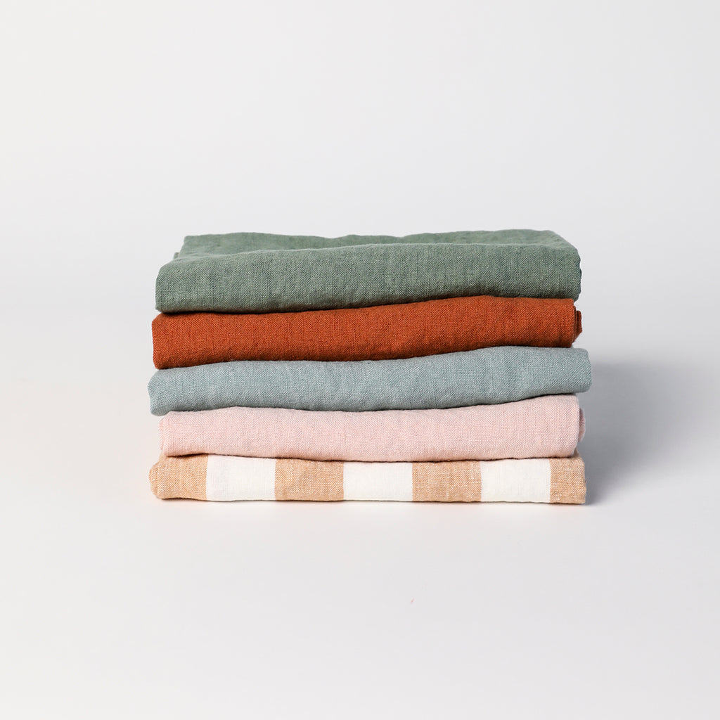 Folded Linge Particulier linen towels in assorted colors