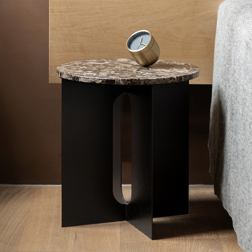 Androgyne Side Table styled as a bedside table with marble top and sculptural steel base