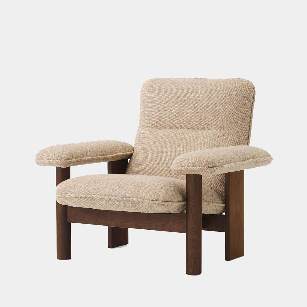Audo Copenhagen Brasilia Lounge Chair in dark stained oak with 02 Menu Bouclé upholstery, shown on a neutral background.