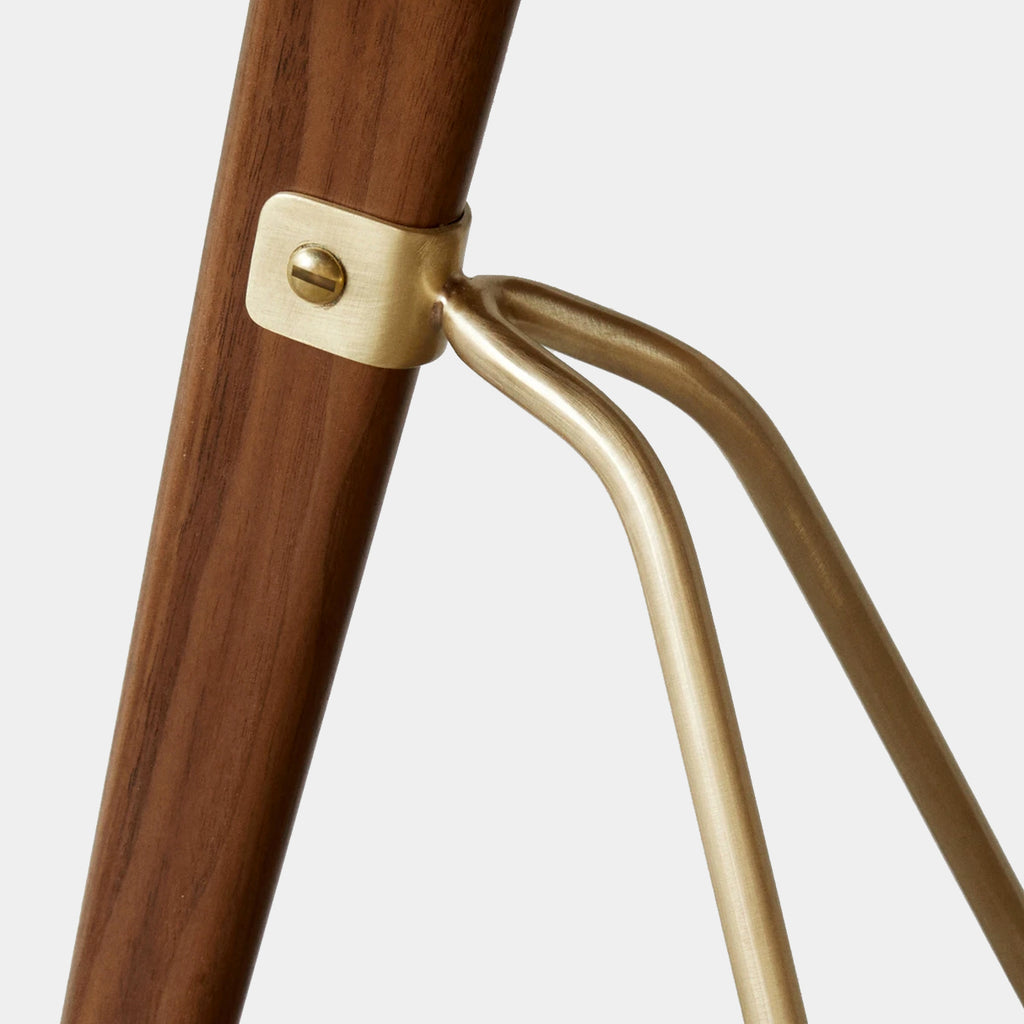 Detail of Umanoff Side Table’s brass leg joint and oiled walnut surface