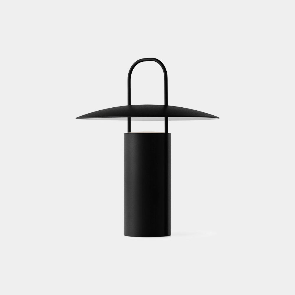 Audo Copenhagen Ray Portable Table Lamp in Black — minimalist powder-coated aluminum design with soft diffused glow.