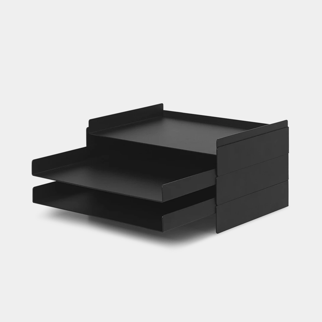 Ferm Living 2x2 Organizer in black powder-coated iron with four open compartments, shown on a wooden workspace.