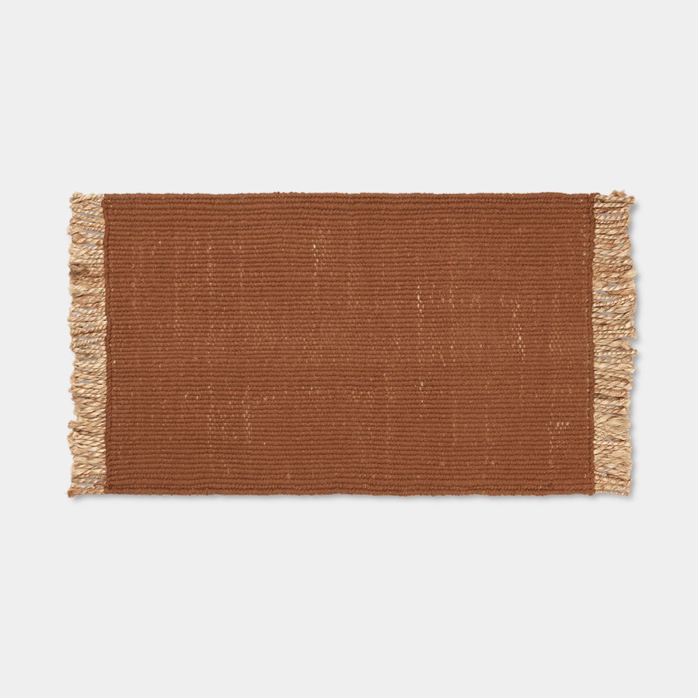 Ferm Living Block Mat in Dark Brick, handwoven jute and cotton with geometric pattern.