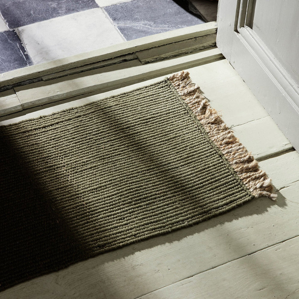 Olive Block mat shown as an entryway mat with natural light showing woven texture of mat.
