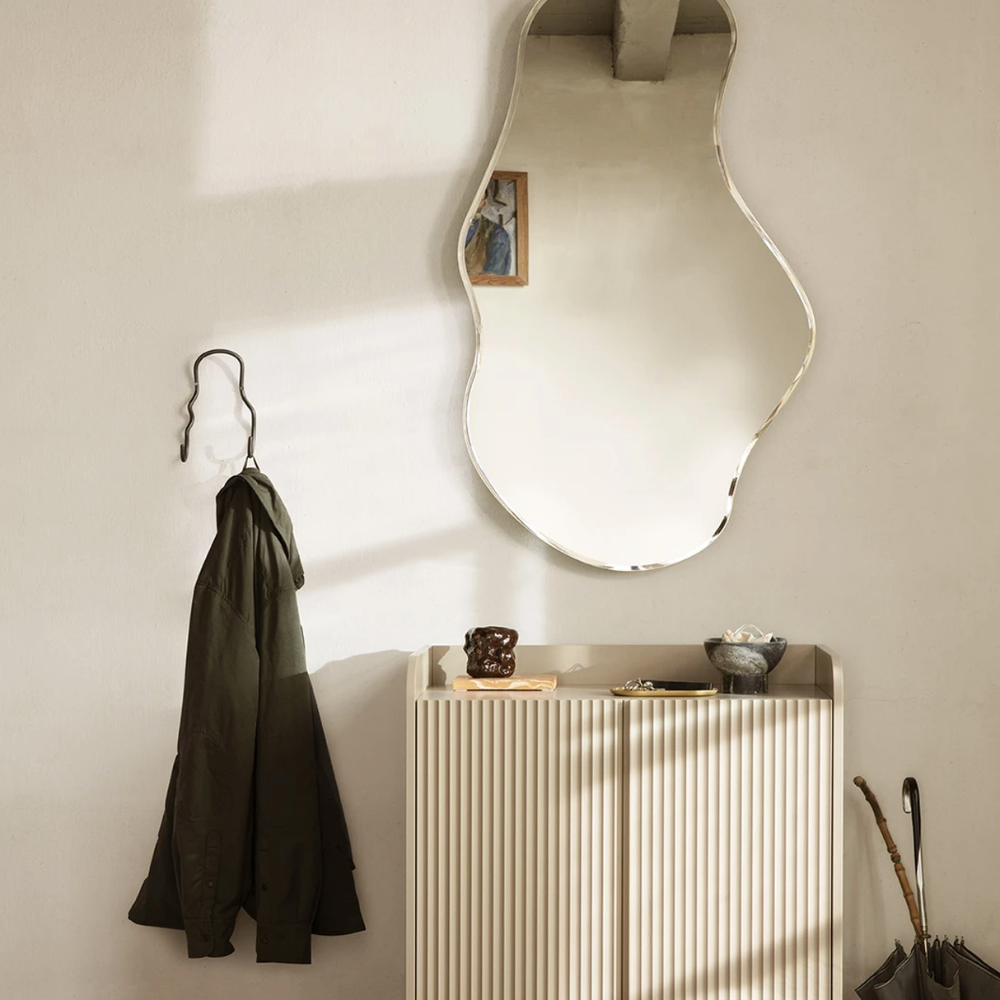 Ferm Living Curvature Double Hook in Black Brass styled next to Pond Mirror.