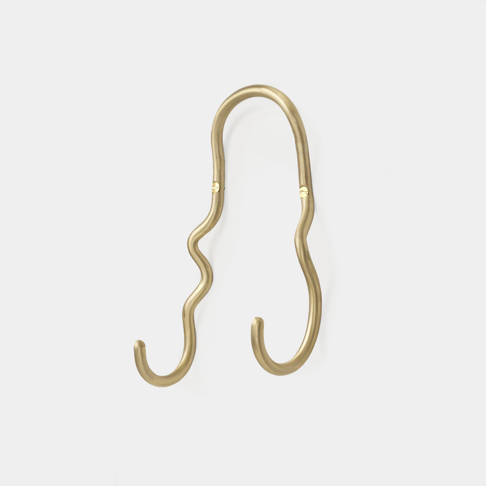 Ferm Living Curvature Double Hook in Brass — hand-formed solid brass wall hook with organic curved silhouette.