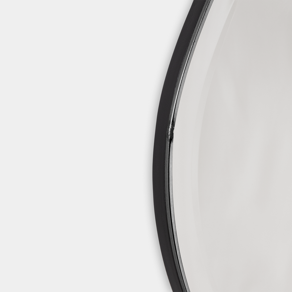 Close-up of Pond Mirror Large in dark chrome showing polished frame and softly curved edge.