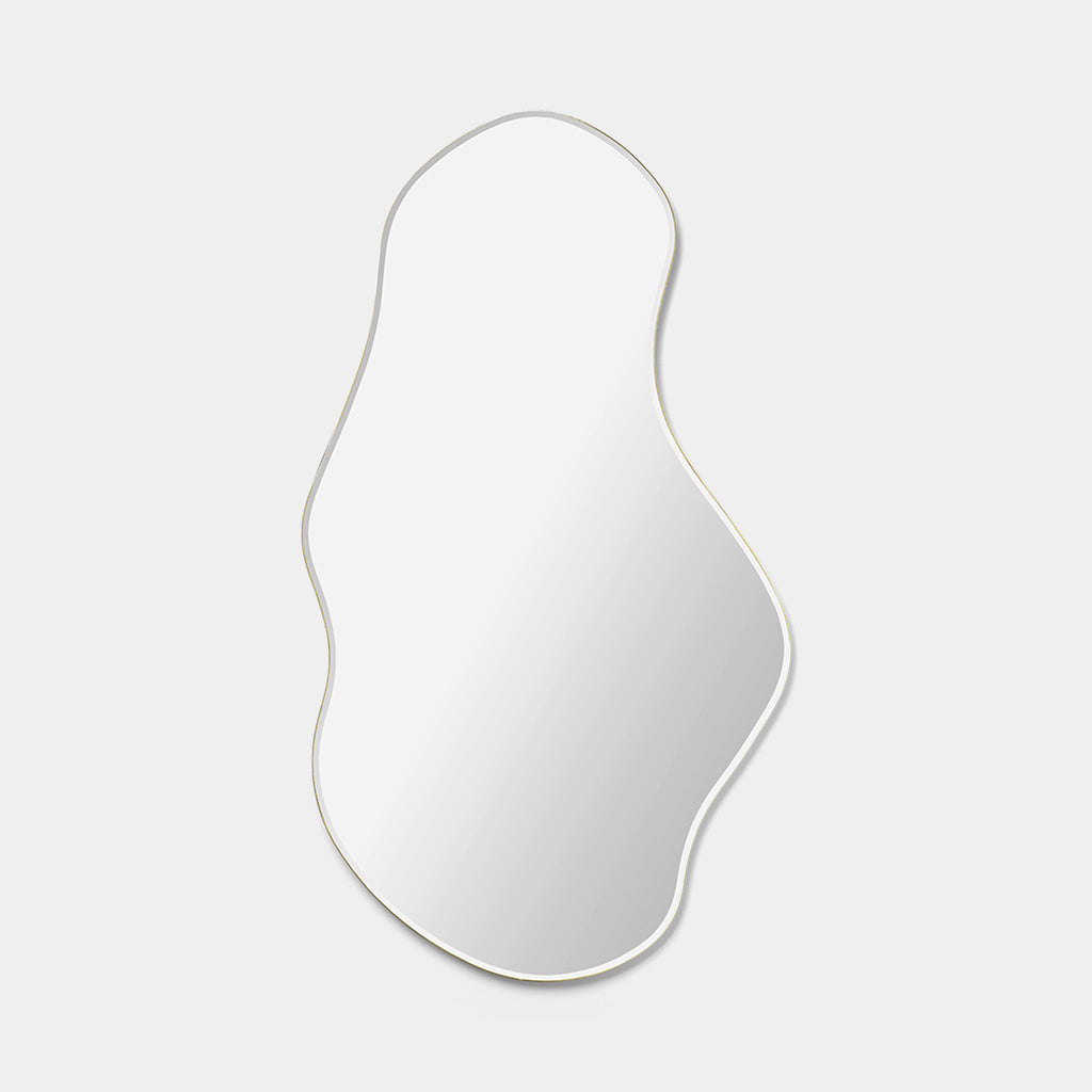 Ferm Living Pond Mirror Large in brass with organic curved frame, shown mounted vertically on a neutral background