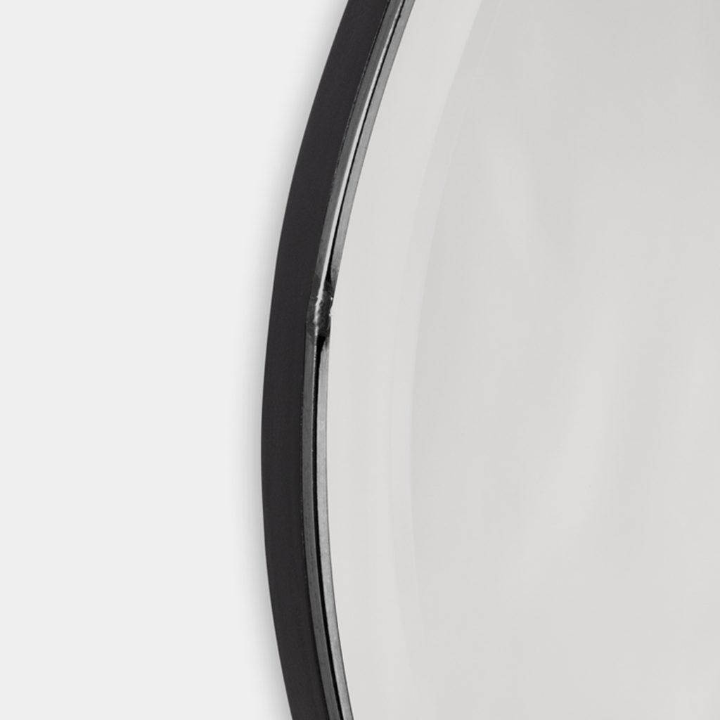 Close-up of Pond Mirror Small in dark chrome showing reflective glass edge and smooth curved metal trim.