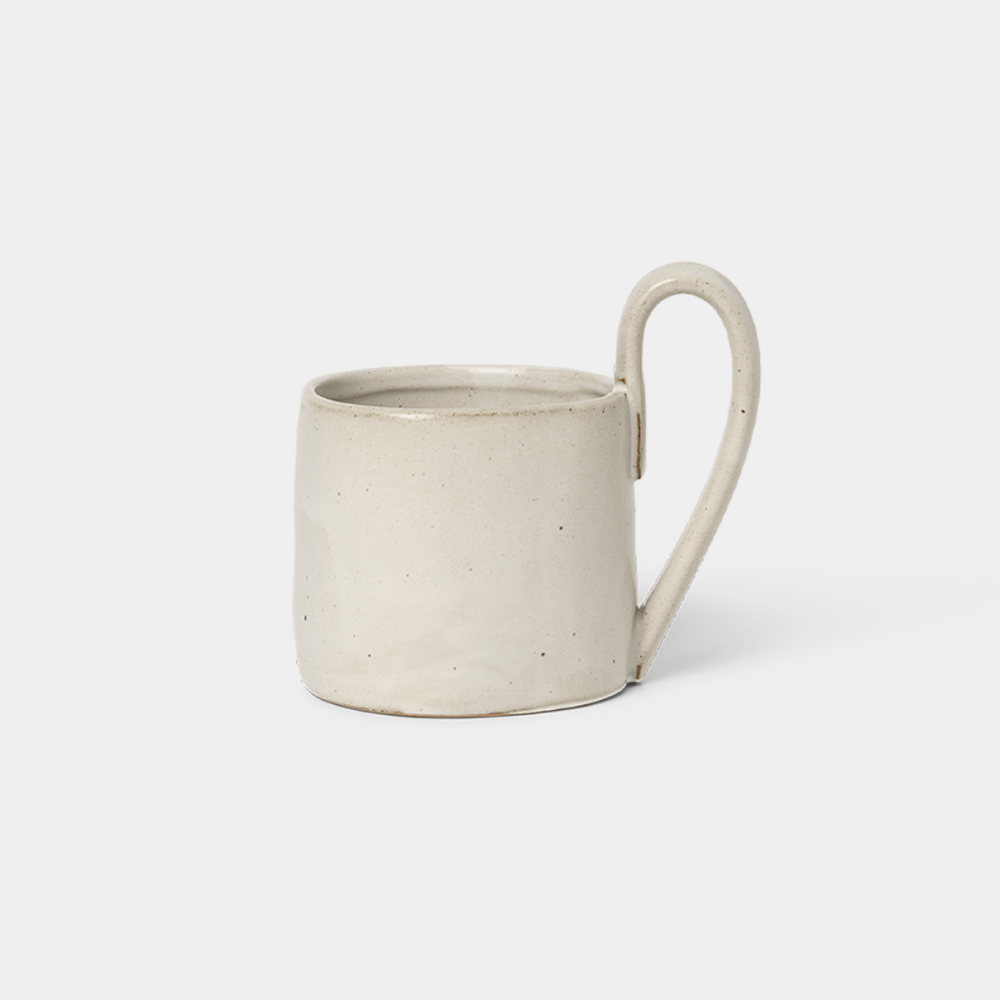 Ferm Living Flow Mug in Off-White Speckle — porcelain mug with semi-matte glaze and sculptural handle.