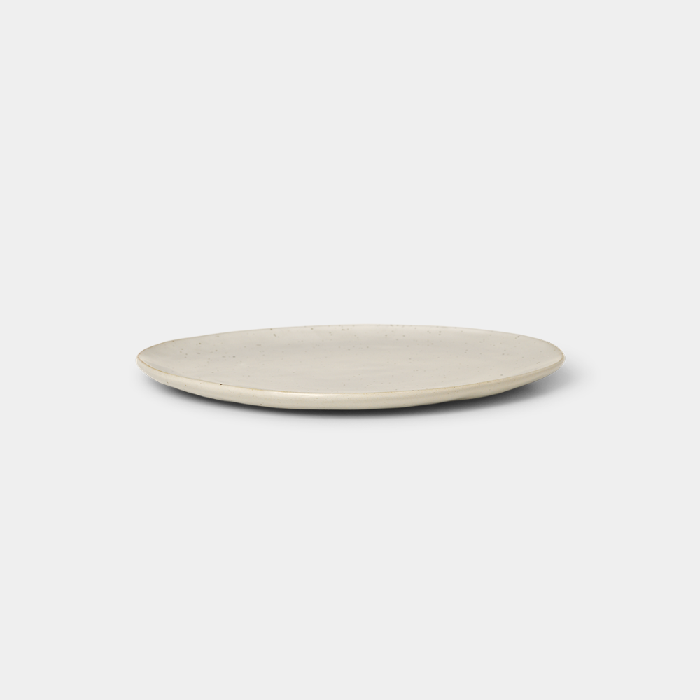 Ferm Living Flow Plate in Off-White Speckle — porcelain plate with semi-matte glaze and organic form.
