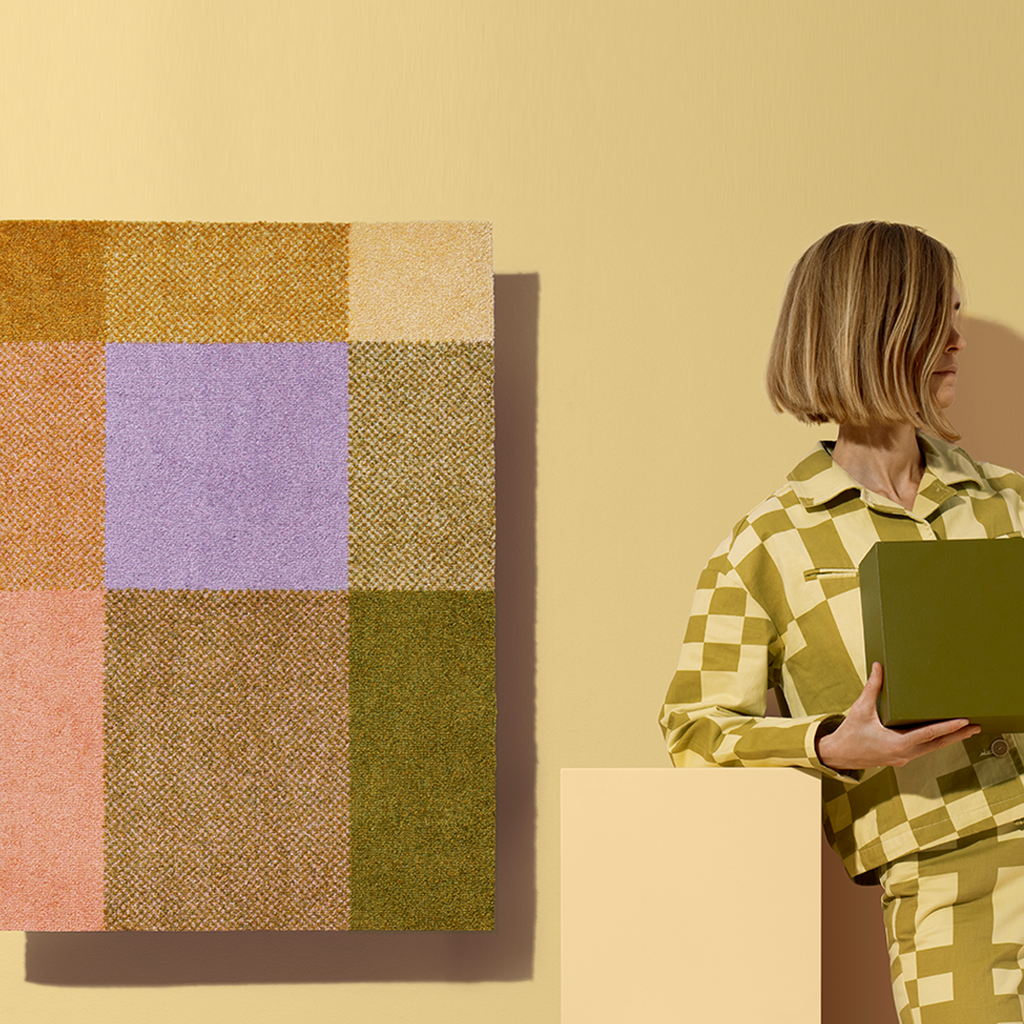 Heymat Mix in color Teklan, washable and slip resistant entryway mat styled on colorful background
