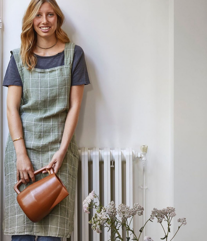 Linge Particuliar Japanese Apron, styled in model in green/grey checks.