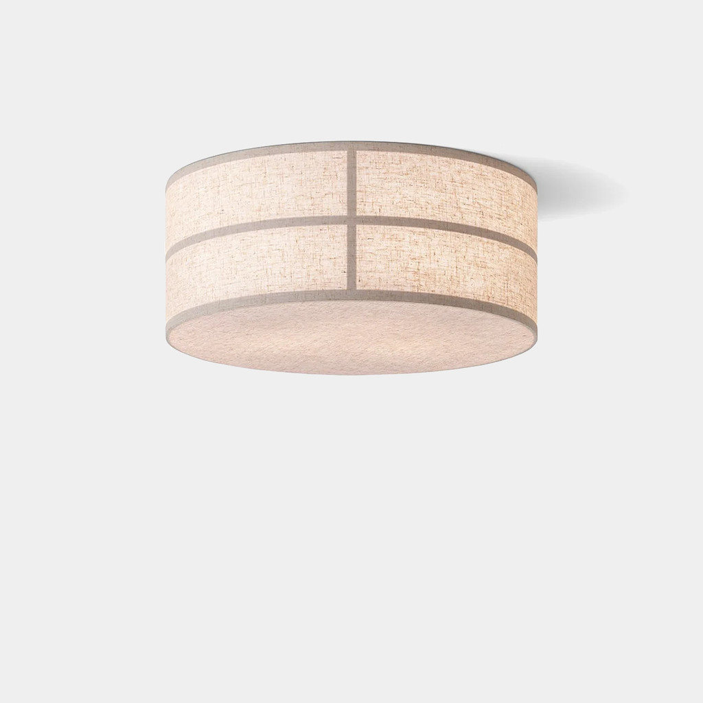 Hashira Ceiling Lamp in raw linen diffusing ambient light through its textured cylindrical shade on neutral background