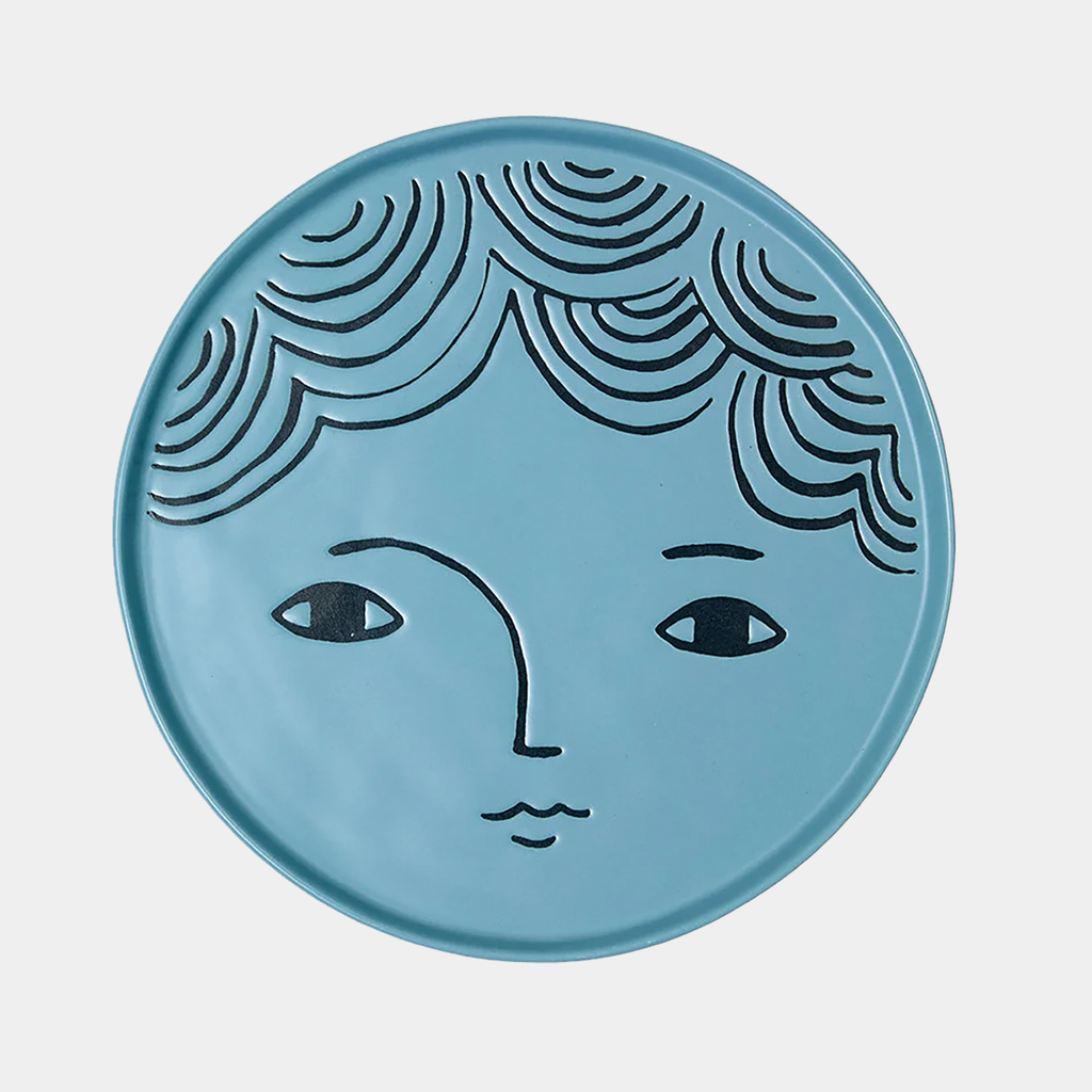 Donna Wilson stoneware plate in blue with illustrated face design.