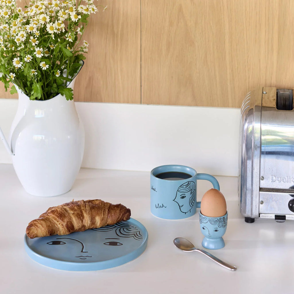 Donna Wilson Face Plate styled croissant on modern kitchen countertop.