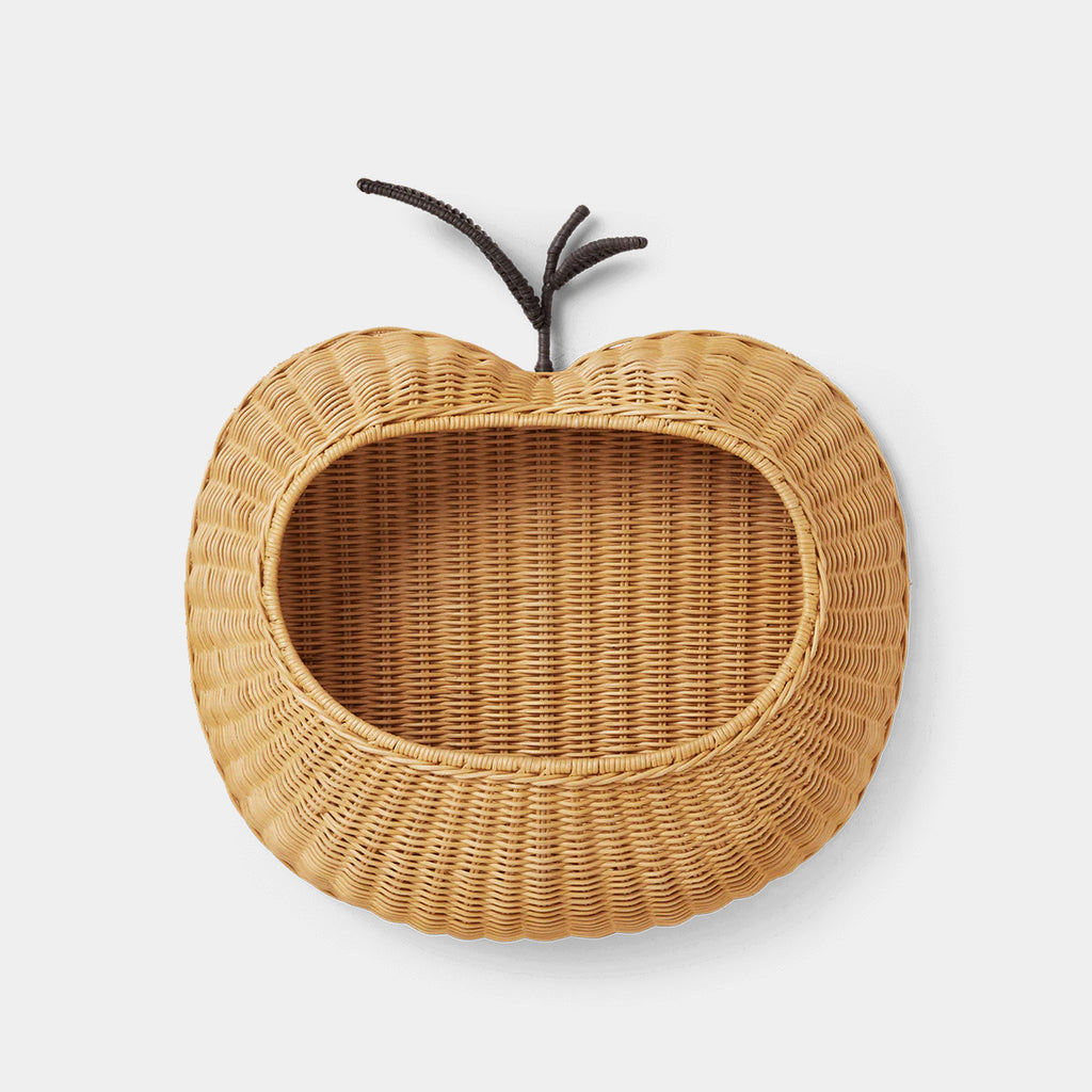 Ferm Living braided apple wall pocket in natural rattan on a neutral background