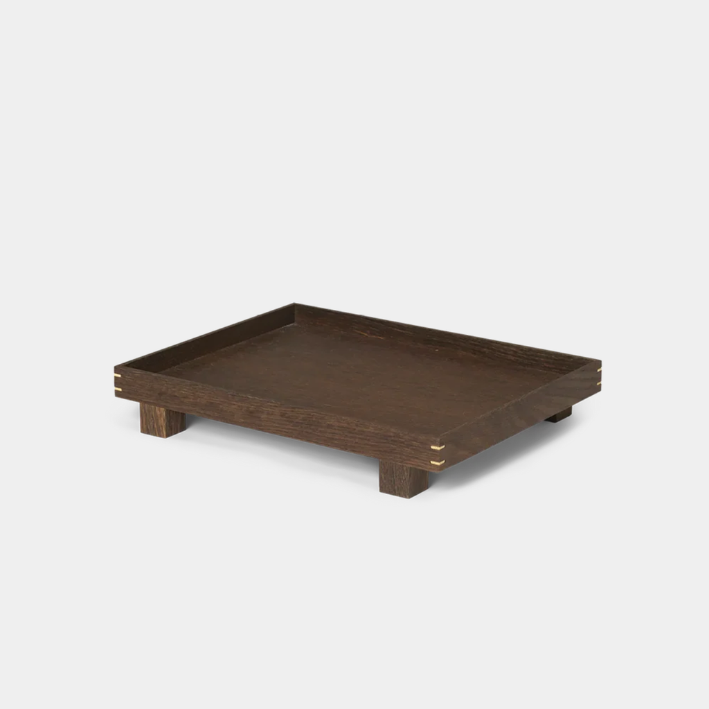 Front view of the Bon Wooden Tray in smoked oak, showing the elevated feet and visible woodworking joints at the corners.