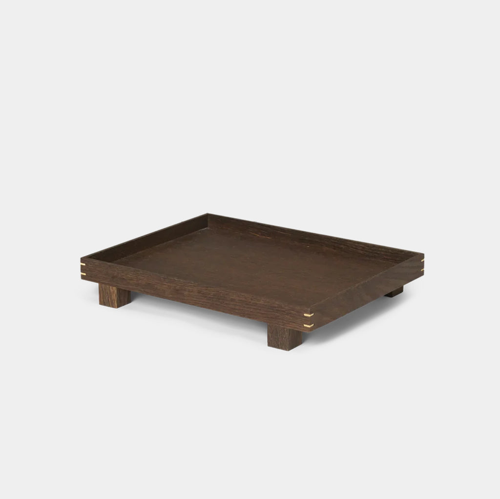 Front view of the Bon Wooden Tray in smoked oak, showing the elevated feet and visible woodworking joints at the corners.
