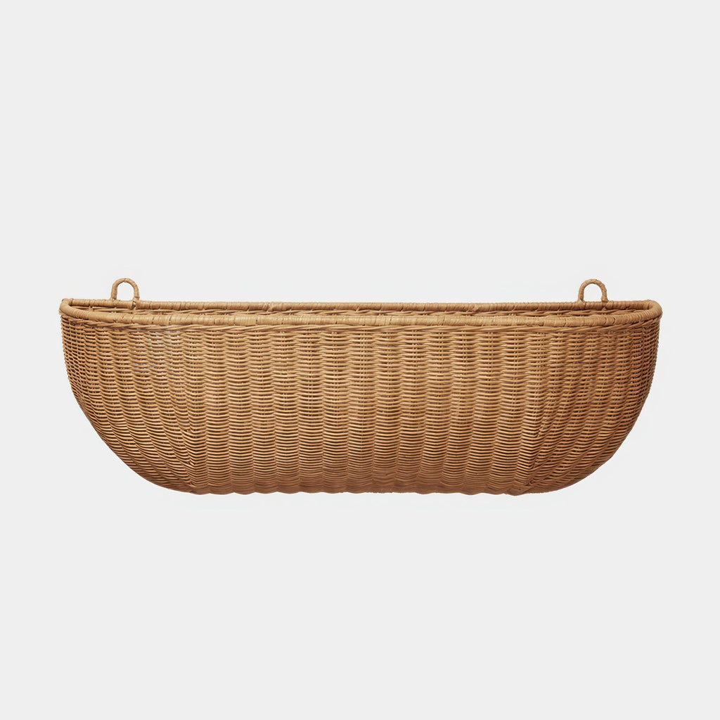 Ferm Living Braided Wall Pocket Wide in hand-braided natural rattan on neutral background