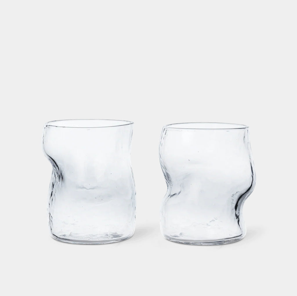 Ferm Living Dimple Glasses in clear hammered mouth-blown glass on neutral background