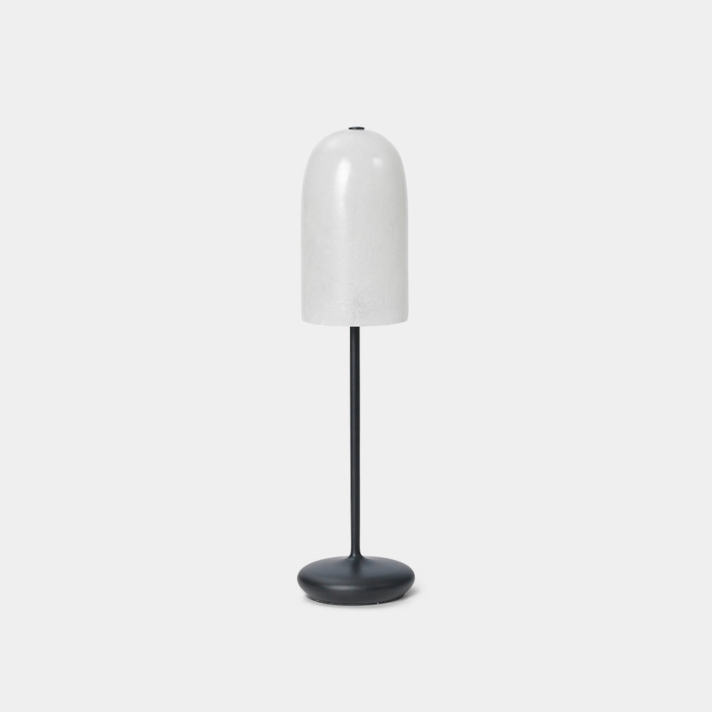 Ferm Living Gry Table Lamp in Black with textured fiberglass shade on a neutral background