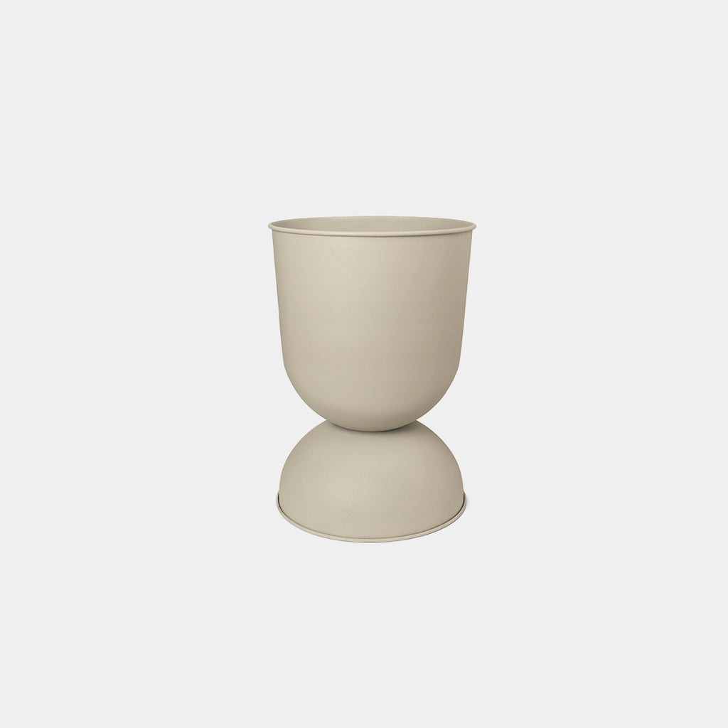 Ferm Living Hourglass Pot in Cashmere, Small — neutral powder-coated iron planter with curved silhouette.