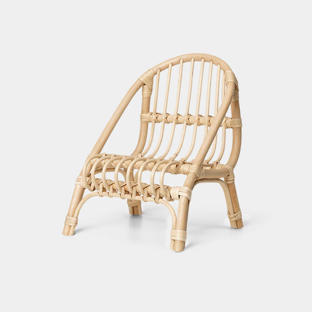 Kuku Doll Chair in natural braided rattan with sculptural woven frame on neutral background