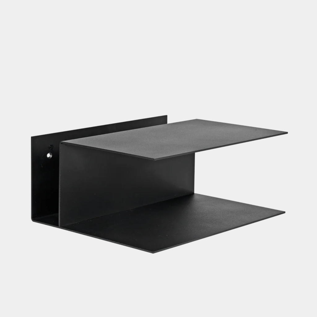 Ferm Living Lager Bedside Table in black powder-coated iron featuring floating wall-mounted shelves with integrated cable cutout