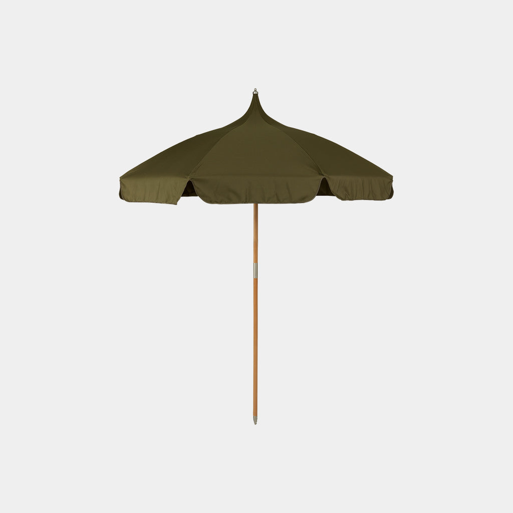 Ferm Living Lull umbrella in military olive with curved canopy and slender pole in outdoor setting