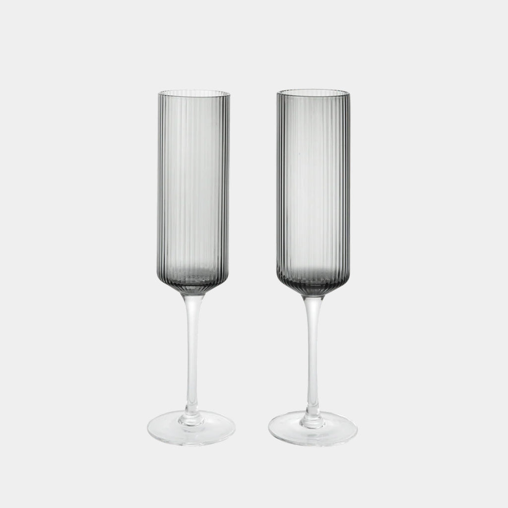 Ferm Living Ripple Champagne Flute in smoked grey mouth-blown glass with vertically ribbed texture and elongated silhouette