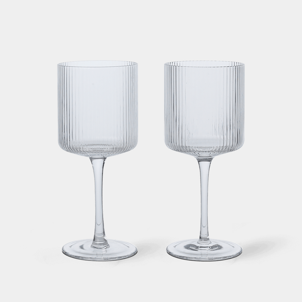 Fluted Ripple white wine glasses by Ferm Living featuring mouth-blown glass and a vertically ribbed surface that catches and reflects light beautifully