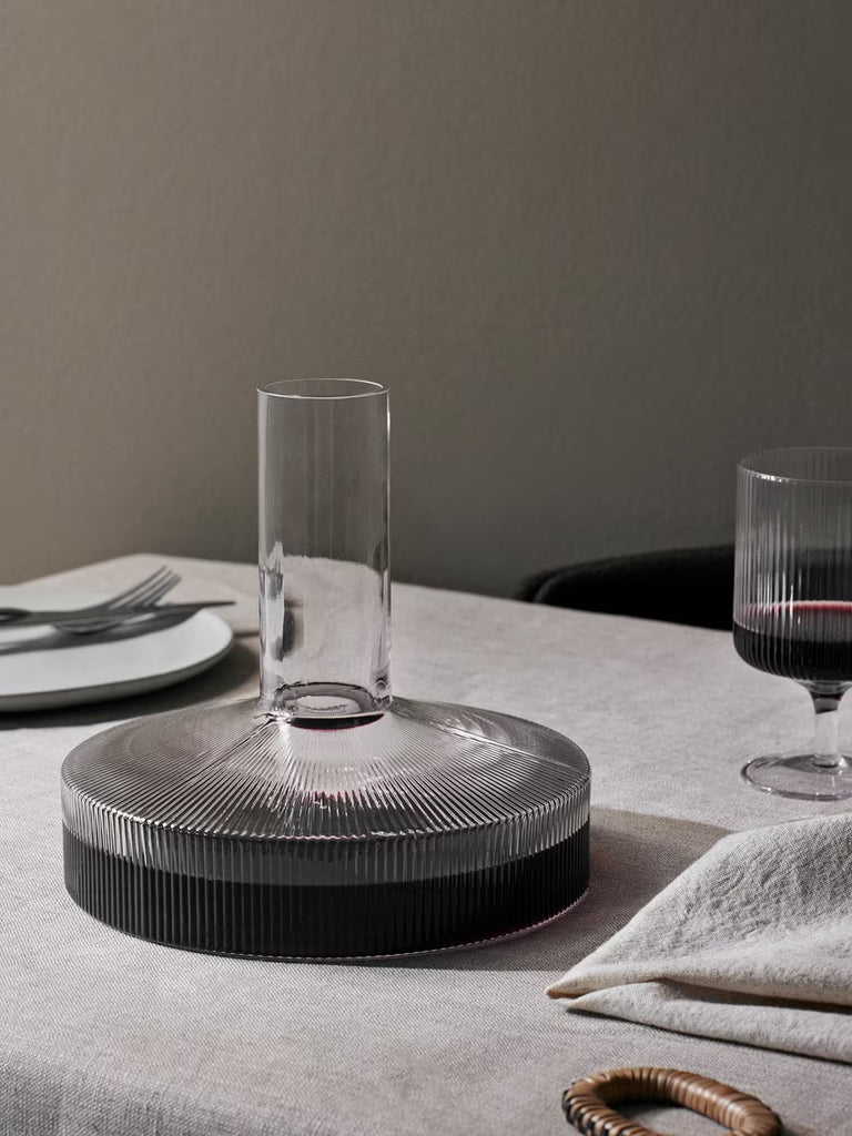 Clear Ripple Wine Carafe by Ferm Living in mouth-blown ribbed glass styled beside matching Ripple stemware for tabletop service