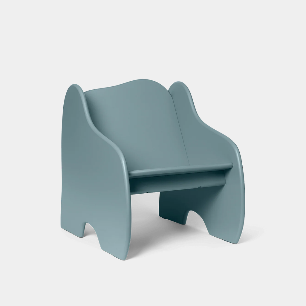 Ferm Living Slope Lounge Chair in Storm with wave-shaped design on neutral background