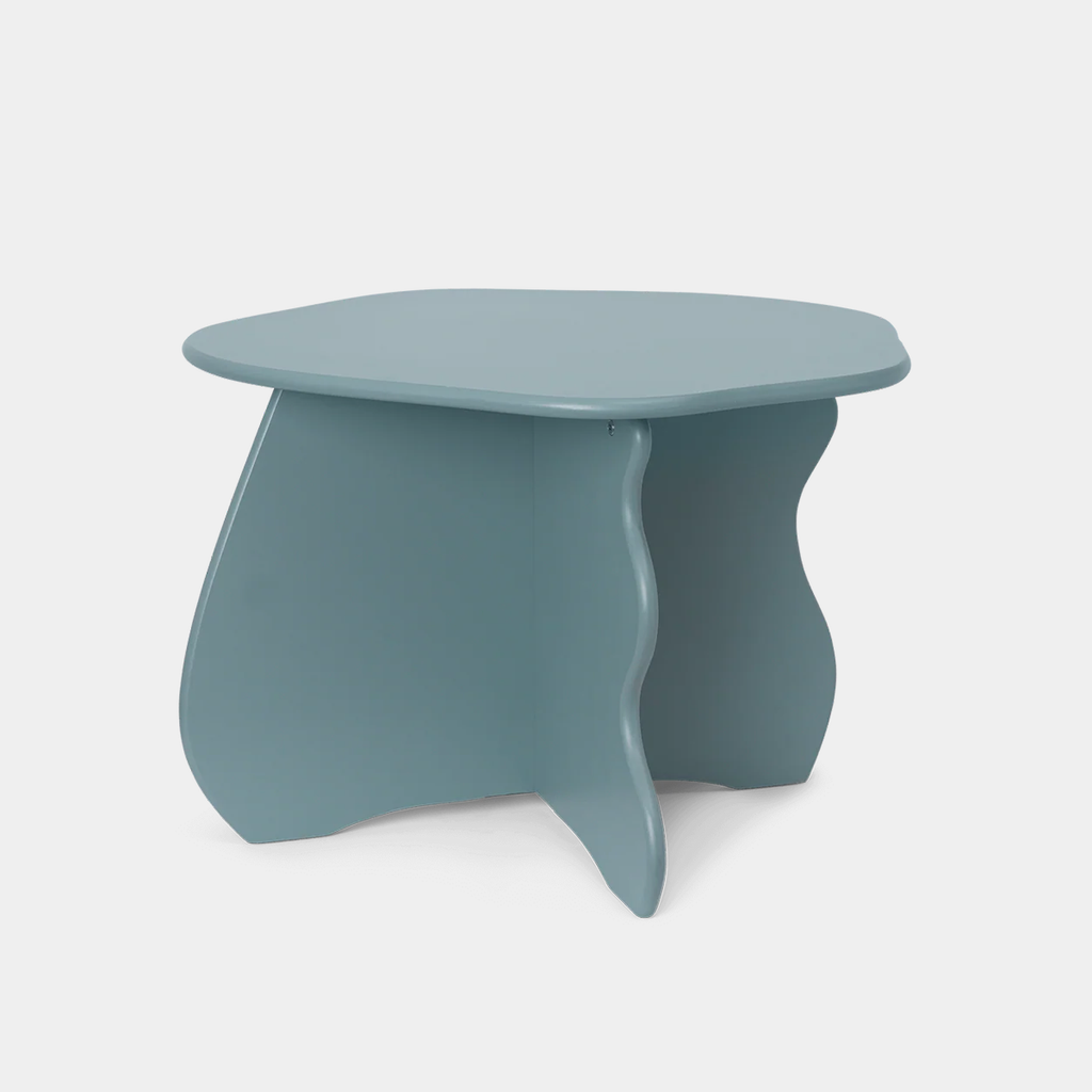 Ferm Living Slope Table in Storm color with wave-shaped design on neutral background