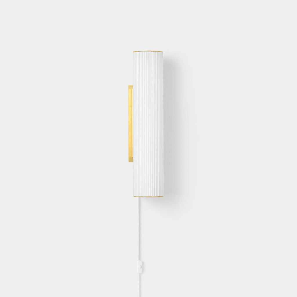 Ferm Living Vuelta wall lamp with rippled opal glass and brushed brass details on a neutral background