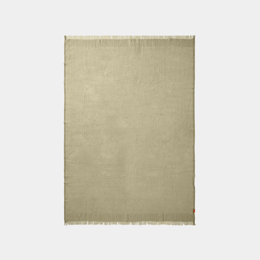 Ferm Living Weaver throw in grey green with fringed edge on neutral background