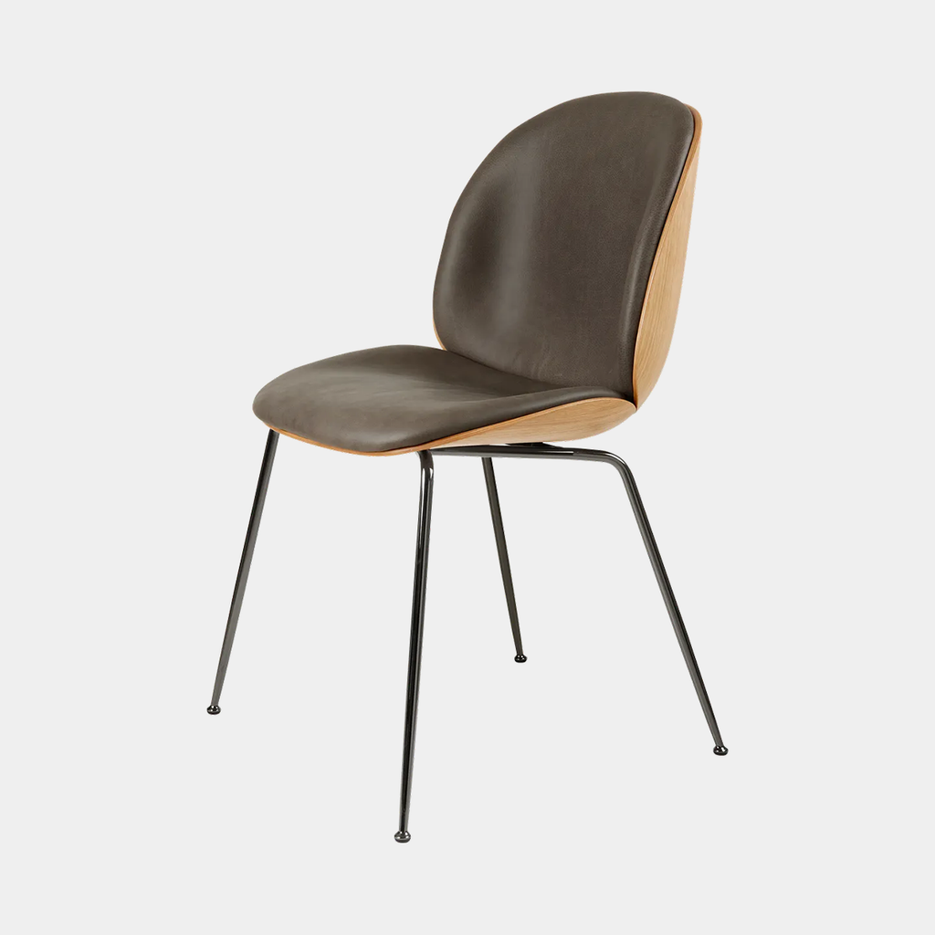 Beetle chair by GUBI with 3D veneer shell and front upholstery in Gubi Smooth Leather Grey, highlighting its sculptural modern form