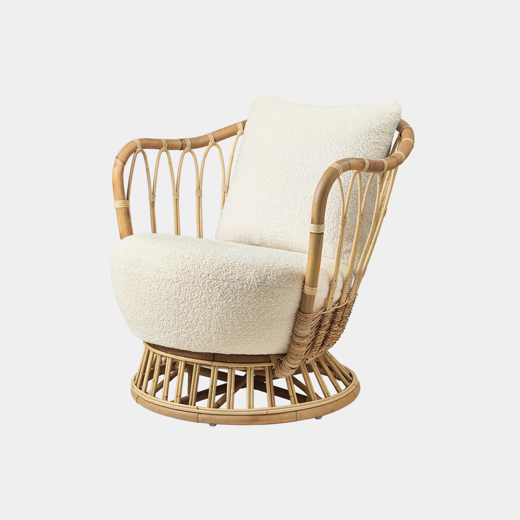 GUBI Grace Indoor Lounge Chair upholstered in Dedar Karakorum fabric with sculptural rattan frame on a neutral background