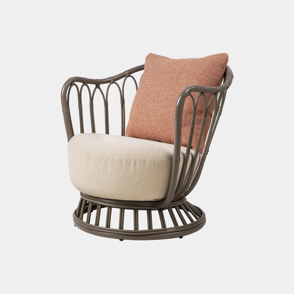 GUBI Grace Outdoor Lounge Chair with rattan frame and outdoor upholstered seat and back cushion in Limonta 44 on a neutral background