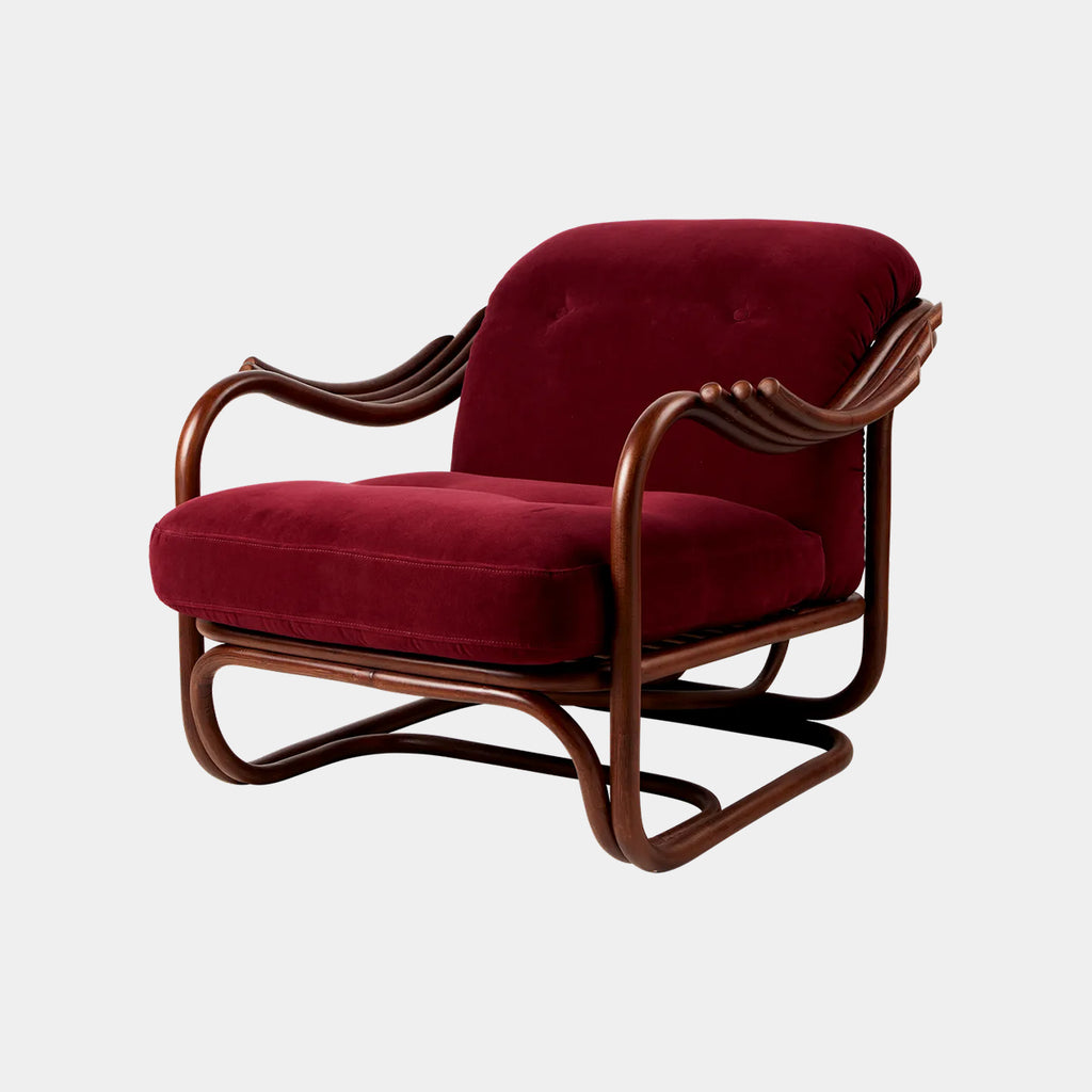 Poltrona Tria lounge chair by GUBI in Fustango 006, highlighting its sculptural rattan silhouette with modernist influence