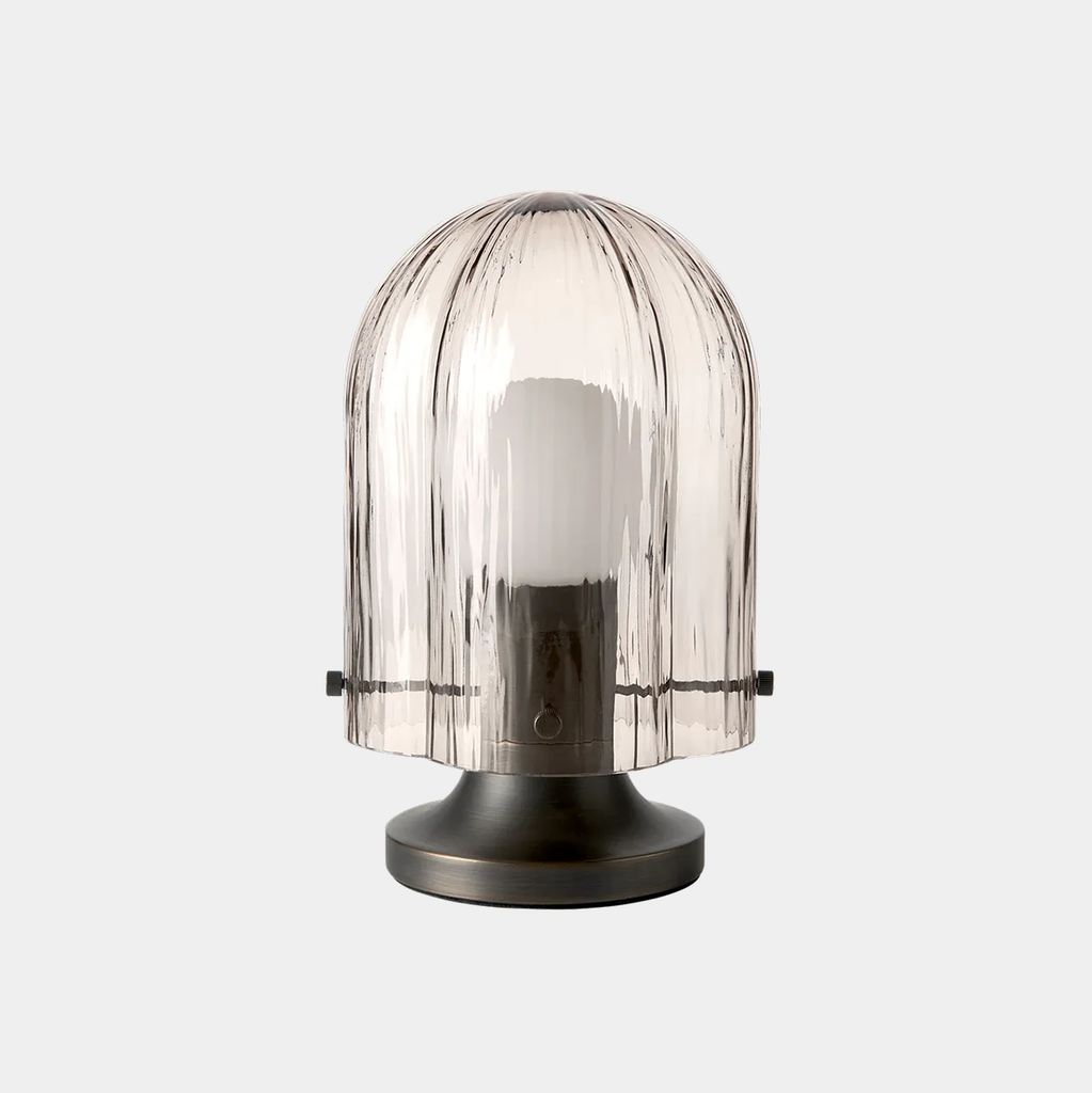 GUBI Seine Table Lamp in Smoke glass with antique brass base highlighting translucent vertical texture.
